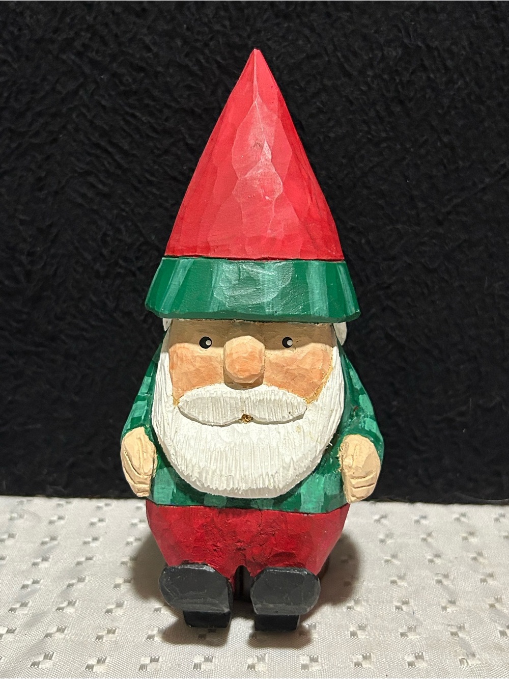 Hand-Carved Wooden Gnome wearing a tall red hat, a green jacket, and black shoes